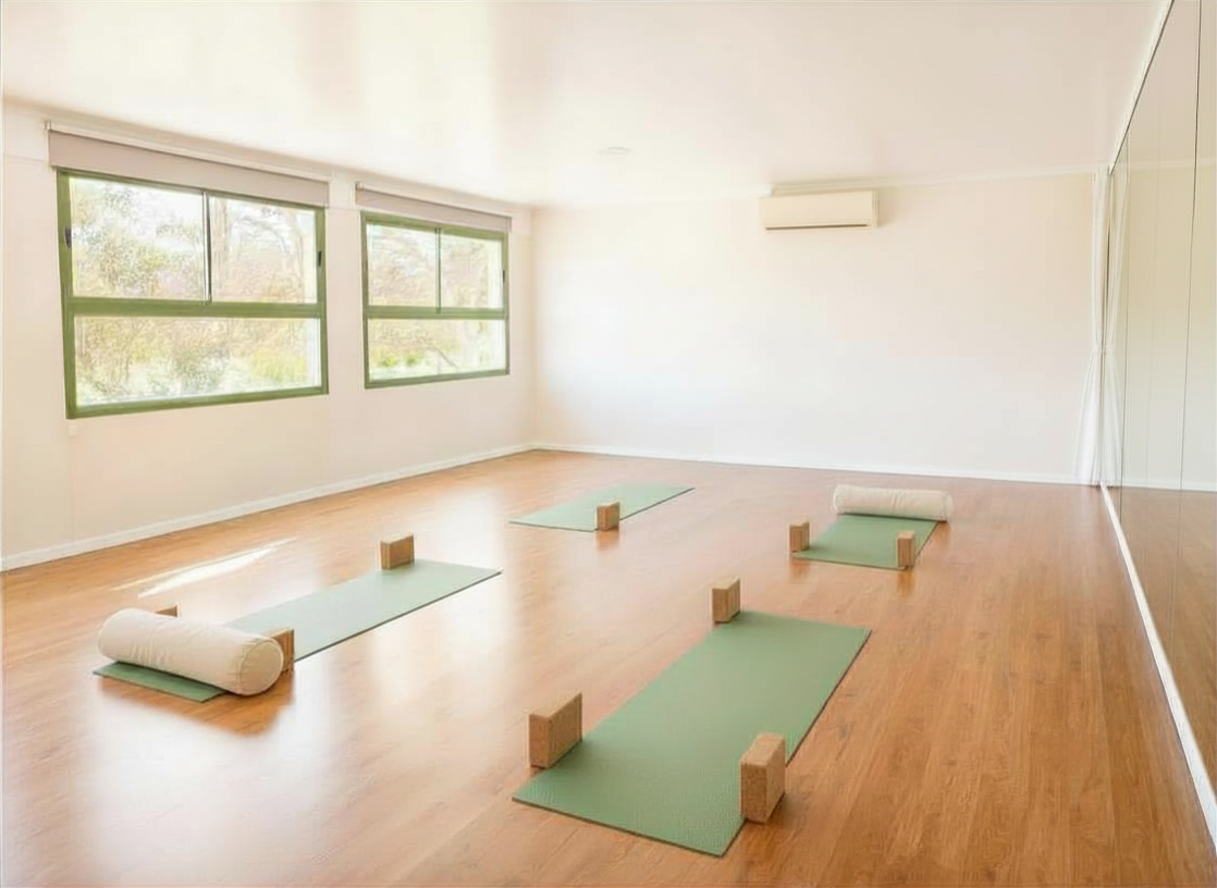 Smart Yoga studio — bright, airy space with yoga mats, natural light and greenery